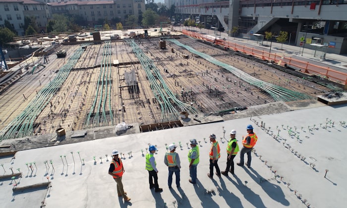 Aerial view of a large civil works site with workers and marked-out ground