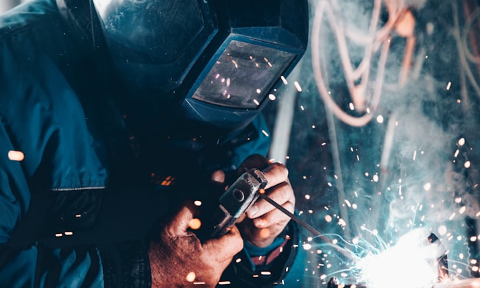 Close-up of metalwork being cut, throwing sparks