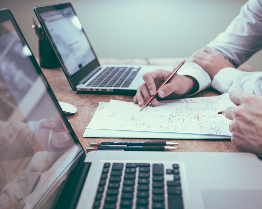 Consultants reviewing registration paperwork with a client at a meeting table
