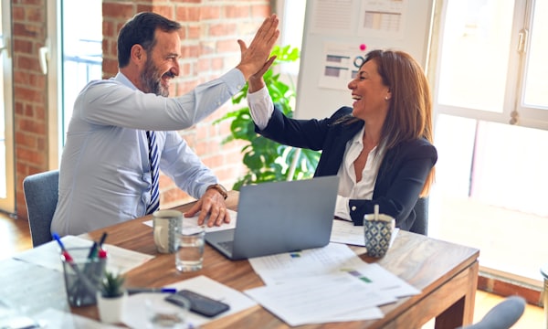 Two business professionals reviewing a contract in a meeting